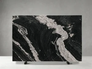 titanium granite slab with black base and dramatic white flowing veins
