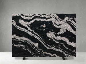 polished titanium granite slab with black surface and white flowing veins
