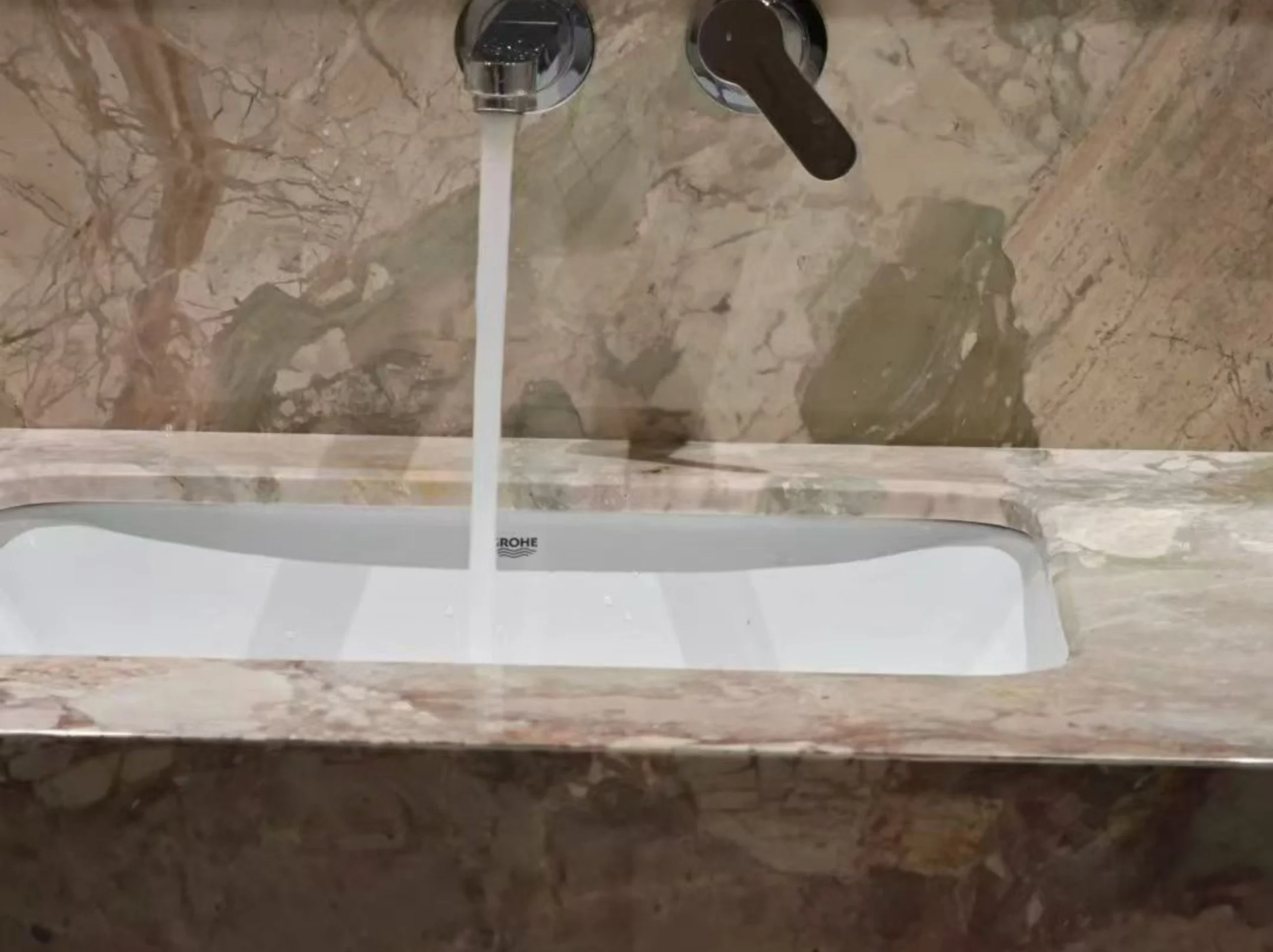 beige-breccia-botticelli-marble-bathroom-vanity-sink-detail-01.webp beige breccia botticelli marble bathroom vanity sink detail with soft beige breccia texture