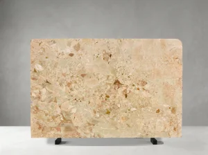 beige breccia botticelli marble rounded tabletop slab with warm beige and pink breccia pattern