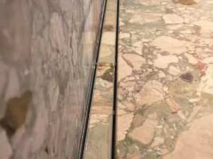 ceppo siciliano marble floor wall edge detail with soft beige green breccia texture