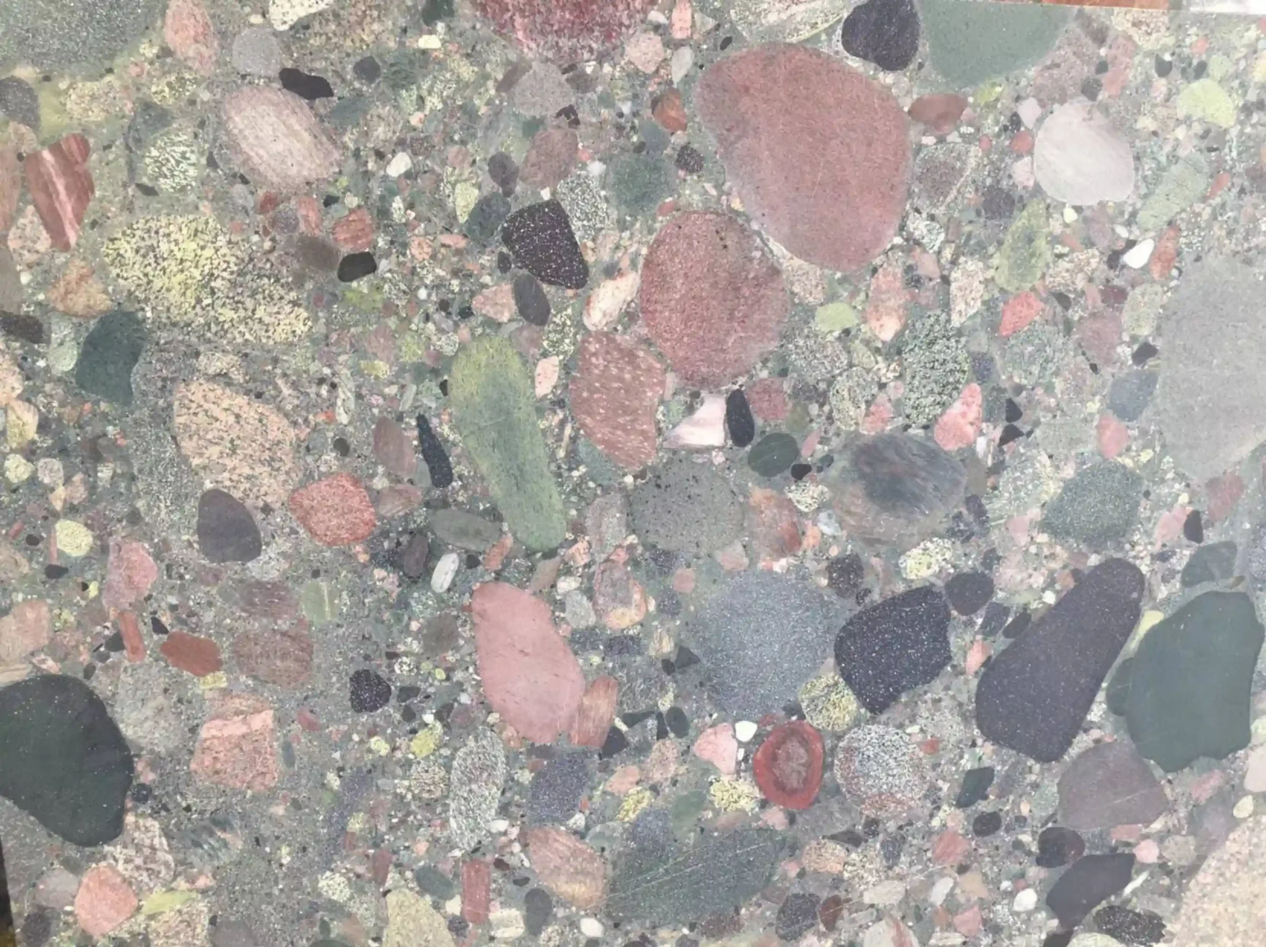 four-season-green-marble-close-up-pebble-texture-03.webp four season green marble close up pebble texture with multicolor mineral fragments