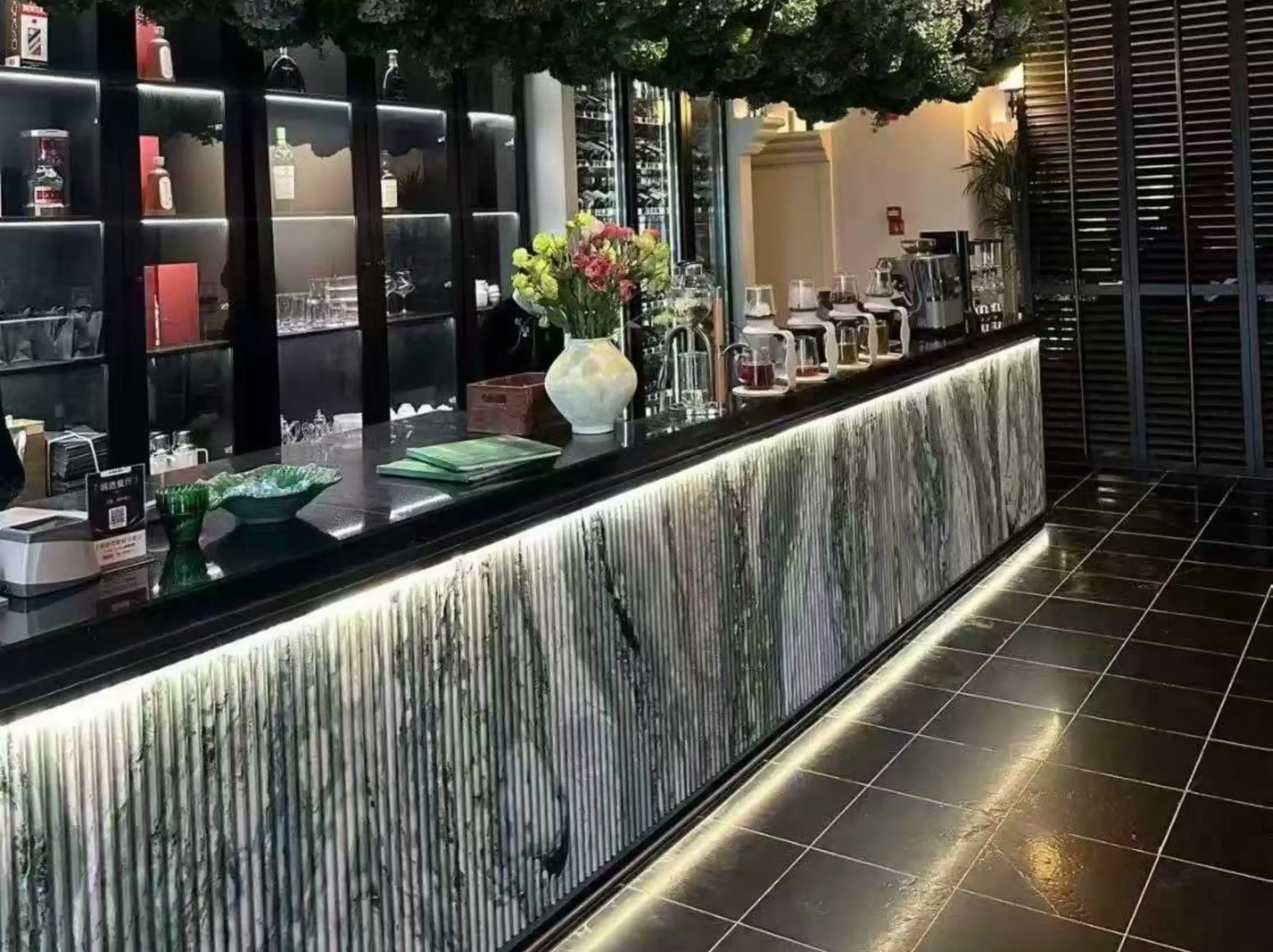 victoria-green-marble-fluted-bar-counter-02.webp victoria green marble fluted bar counter with soft green white veining