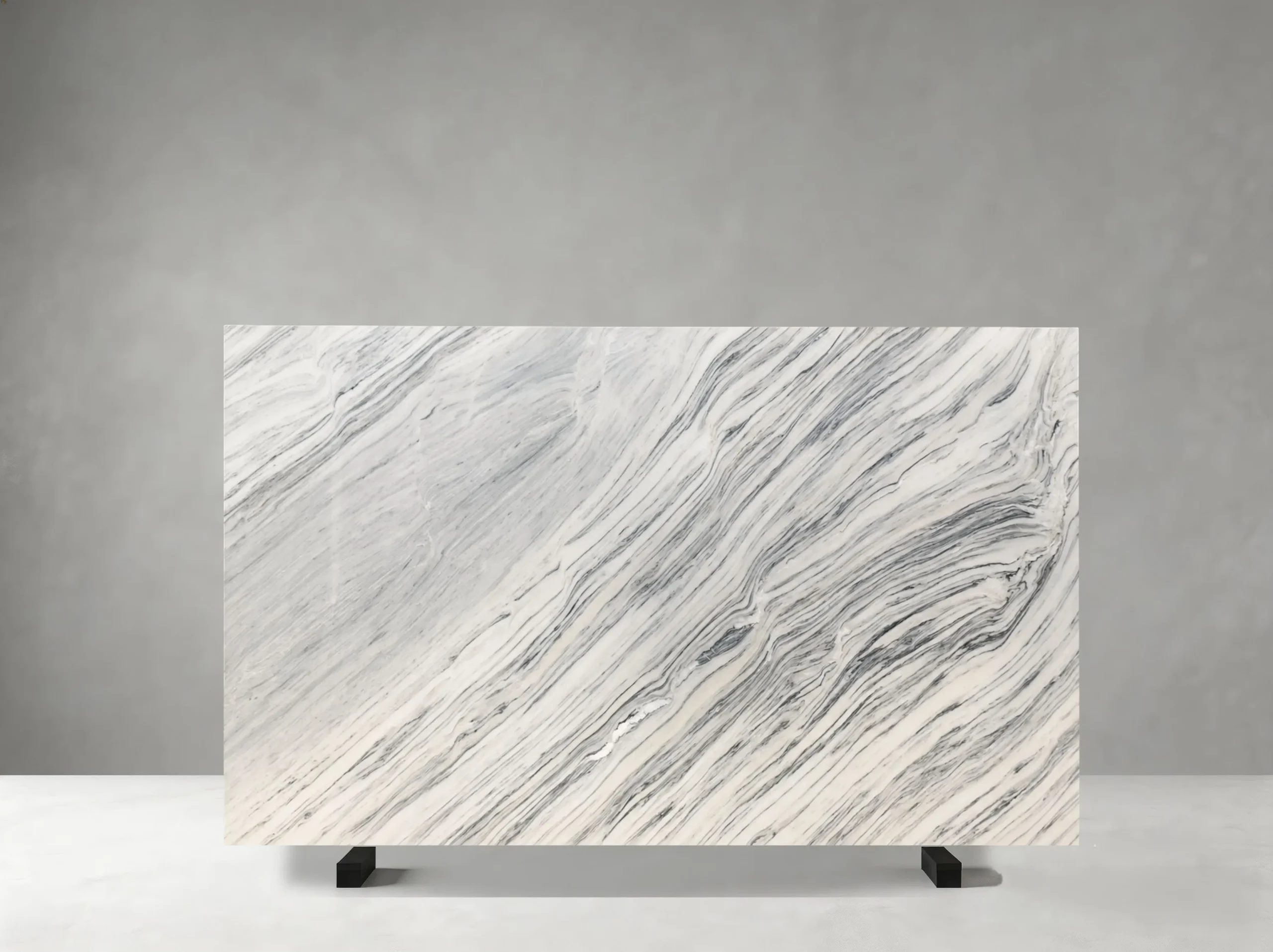 bianco-ondulato-marble-flowing-wave-vein-slab.webp Bianco Ondulato Marble slab with flowing wave-like grey veins on a white background