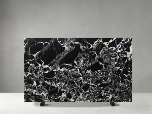 black grand antique marble slab with black base and white breccia stone fragments