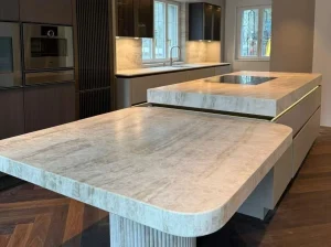 Branco Taj Mahal Quartzite kitchen island with rounded edges and warm beige veining