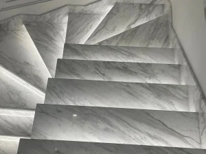 Branco Volakas Marble staircase with custom treads, risers and integrated LED lighting