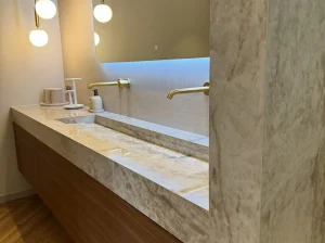 Custom Brazilian Perla Venata Quartzite wall cladding with layered white crystalline veining