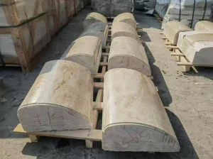 Custom semi-round Brazilian Taj Mahal Quartzite column components arranged in the stone factory