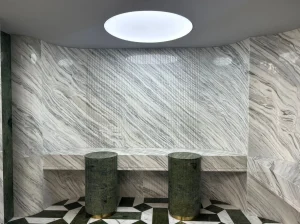 Calacatta Armani Marble wall cladding and geometric flooring in a luxury commercial interior