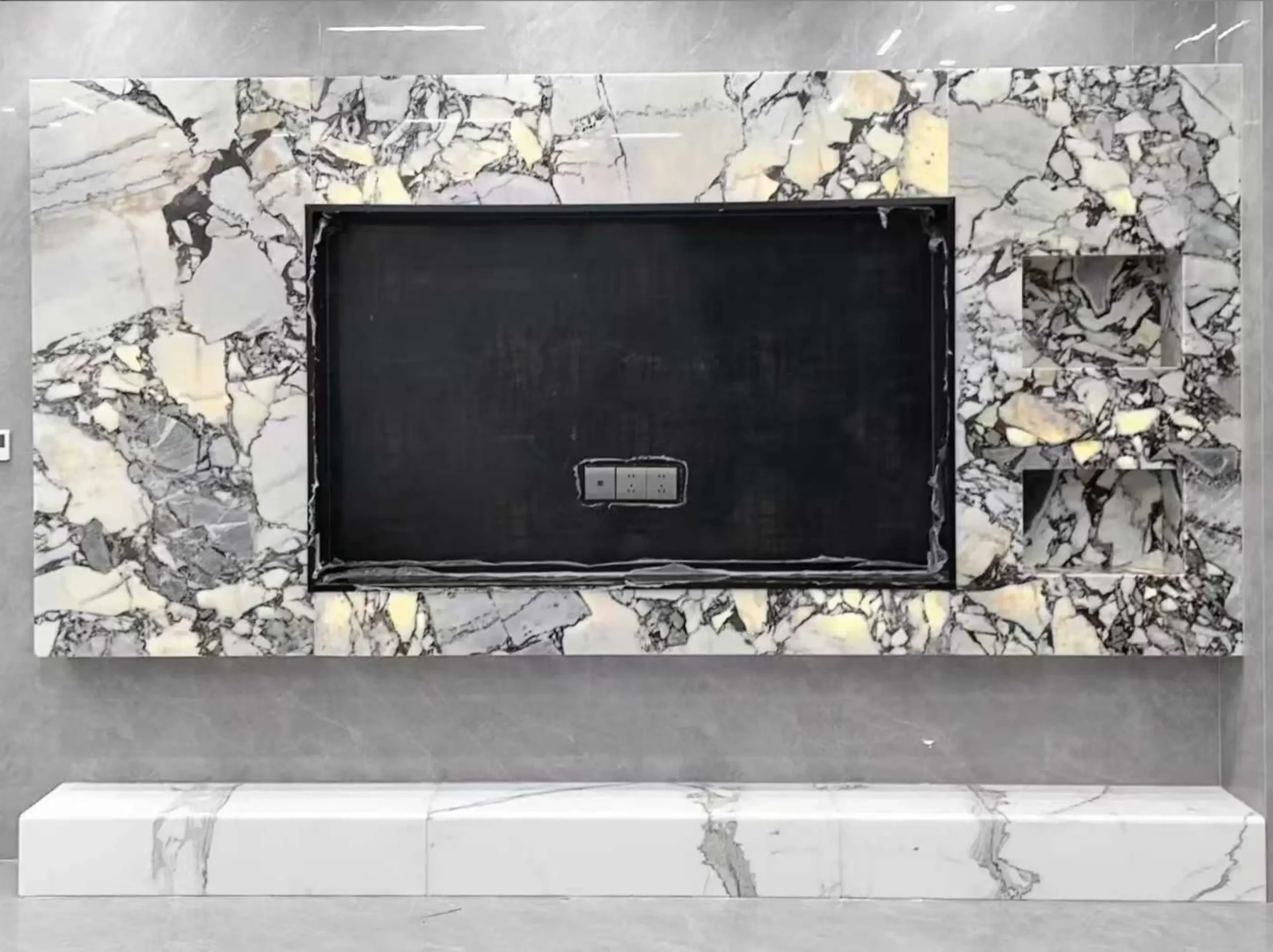 chinese-bvlgari-marble-tv-wall-cladding-03.webp chinese bvlgari marble tv wall cladding with ivory grey and charcoal brecciated fragments