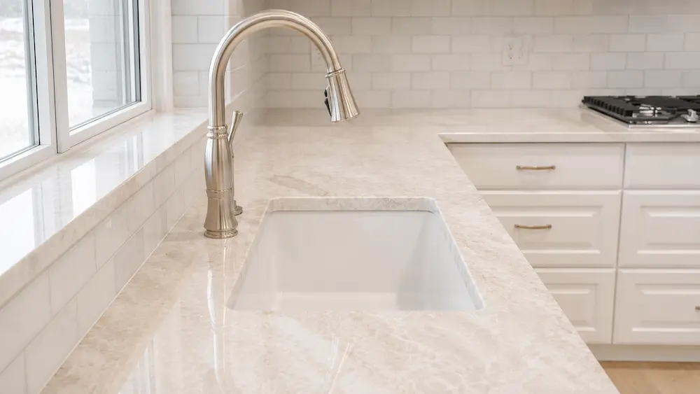 Taj Mahal Quartzite Kitchen Countertop Sink Detail Taj Mahal Quartzite kitchen countertop with undermount sink and cream stone detail