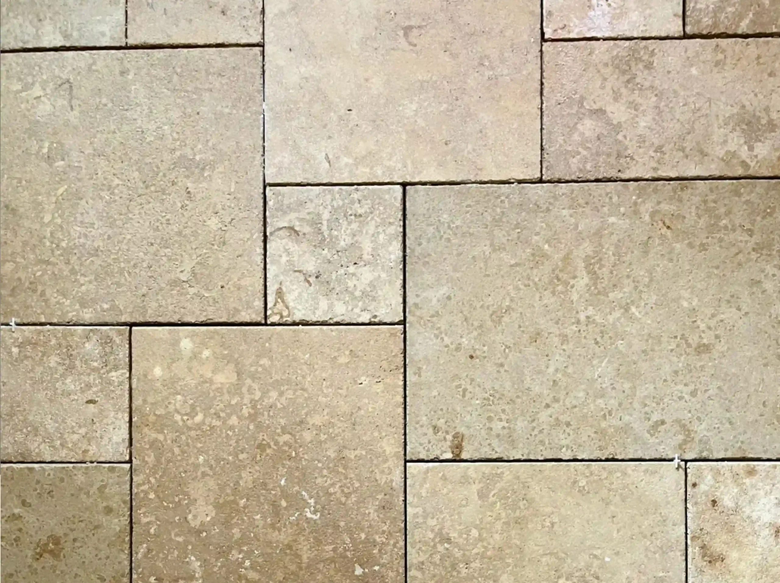 german-beige-limestone-tile-layout-detail-03.webp german beige limestone mixed size tile layout with natural pores and beige texture