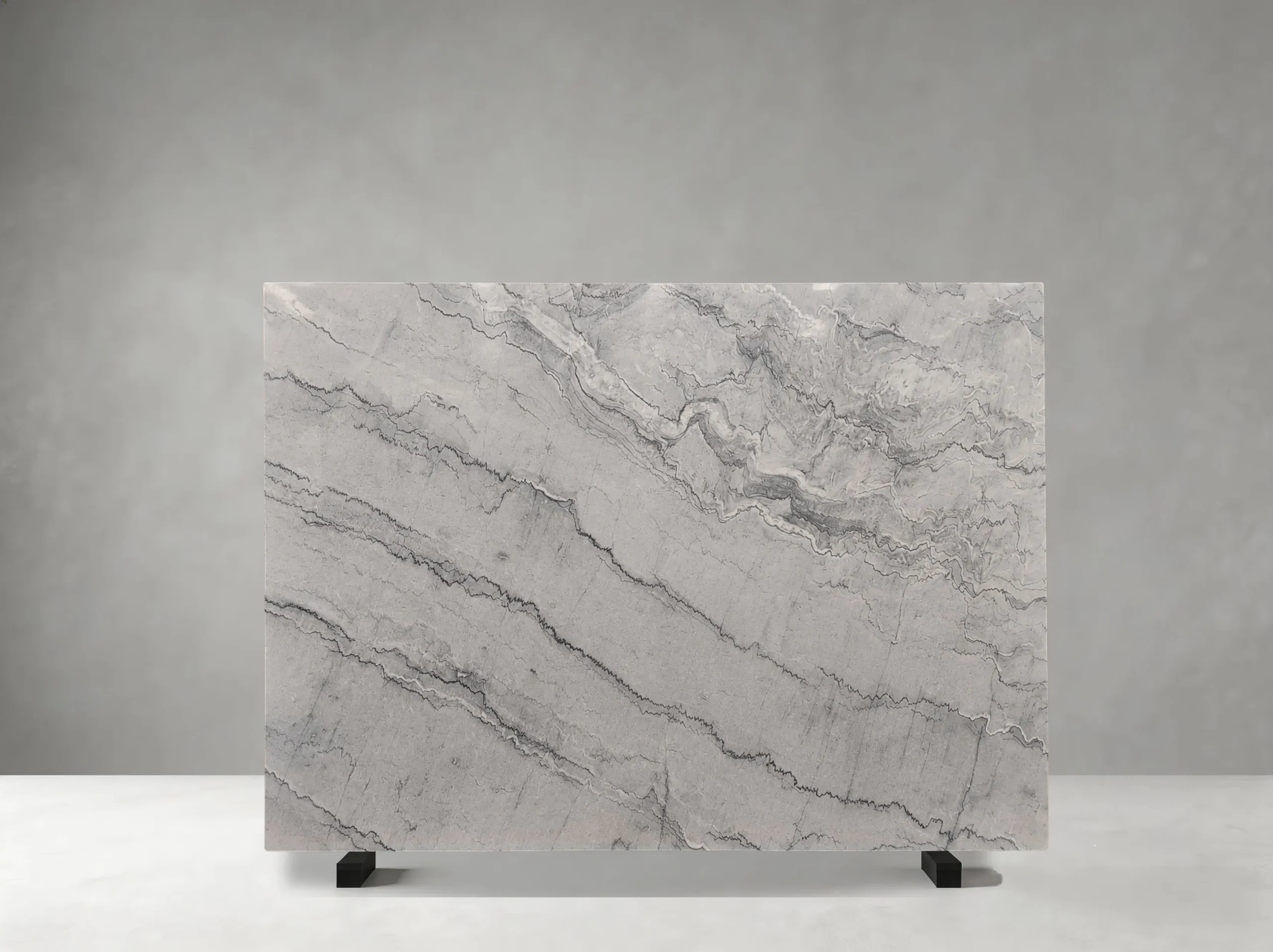 gray-bruce-marble-slab-grey-linear-movement-03.webp gray bruce marble slab with light grey background dark linear bands and layered natural movement