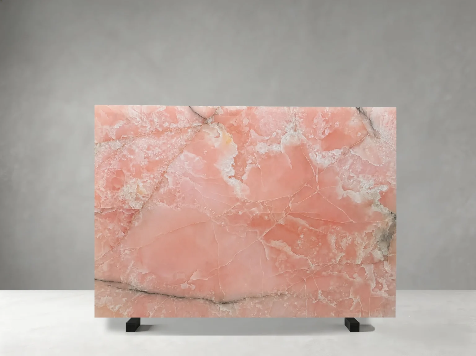 Polished Iris Pink Onyx slab with coral-pink colour, white crystalline formations, and fine grey veins