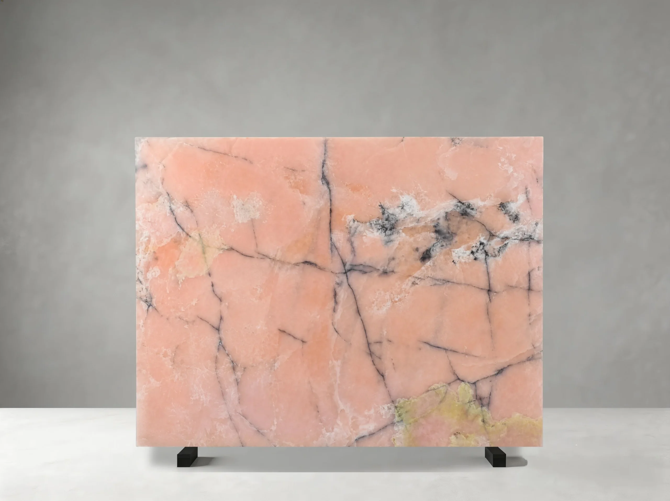 iris-pink-onyx-slab-dark-veins-front-view-04.webp Front view of an Iris Pink Onyx slab with coral tones, dark mineral veins, and golden accents