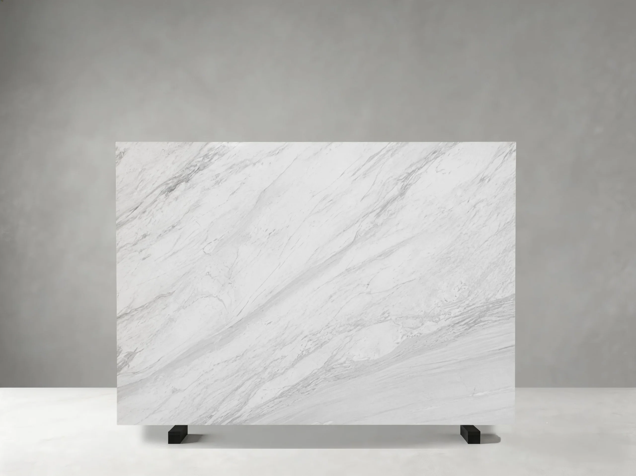 jazz-white-marble-flowing-grey-veins-slab.webp Jazz White Marble slab with prominent flowing grey veins on a white background