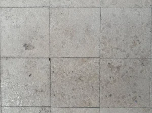 jura gelb limestone tile close up with fossil pores and natural beige texture