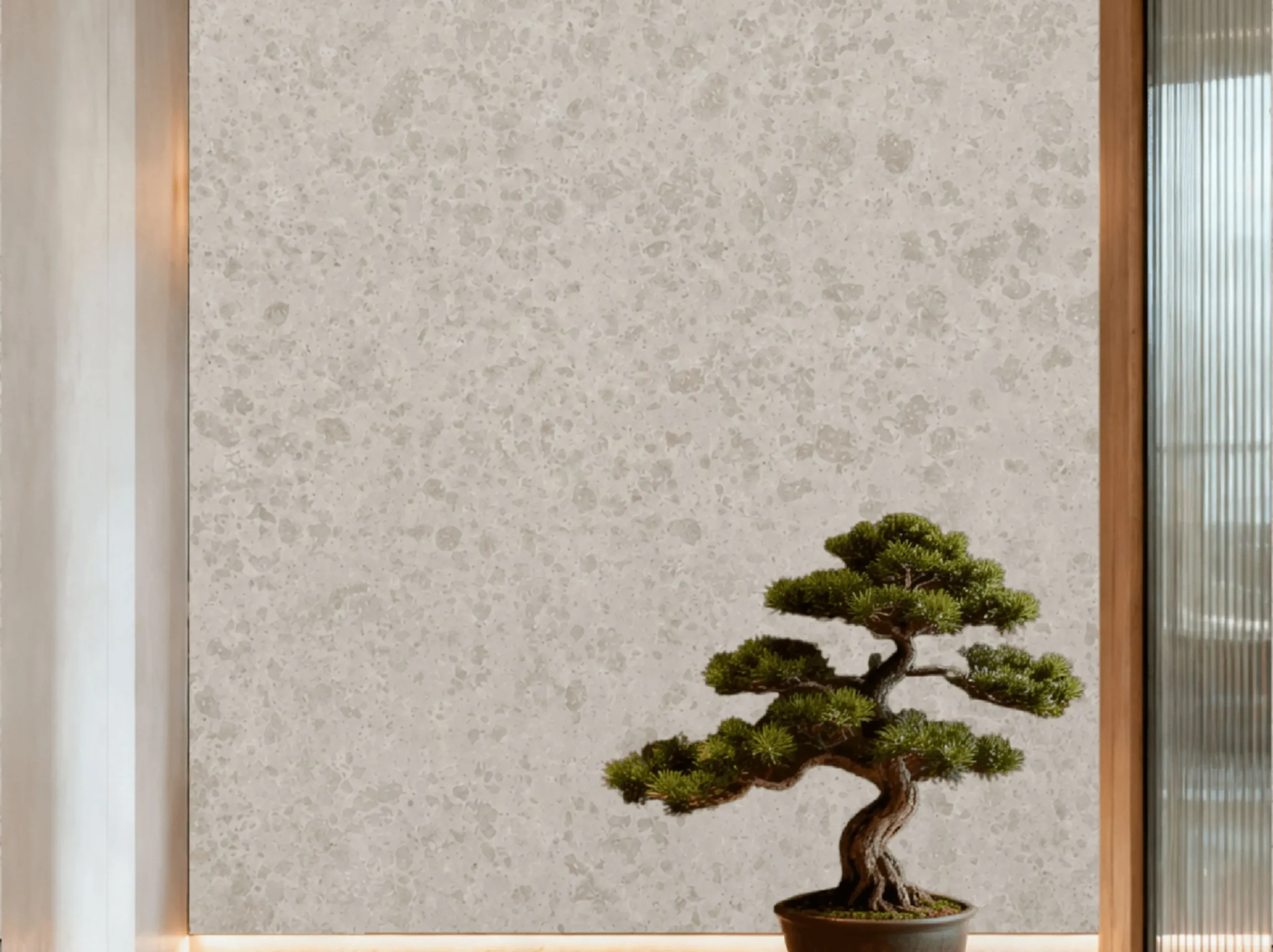 jura-gelb-limestone-feature-wall-bonsai-01.webp jura gelb limestone feature wall with warm beige fossil texture and bonsai decor