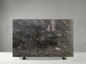 kozmus black granite slab with charcoal grey and warm gold flowing mineral movement