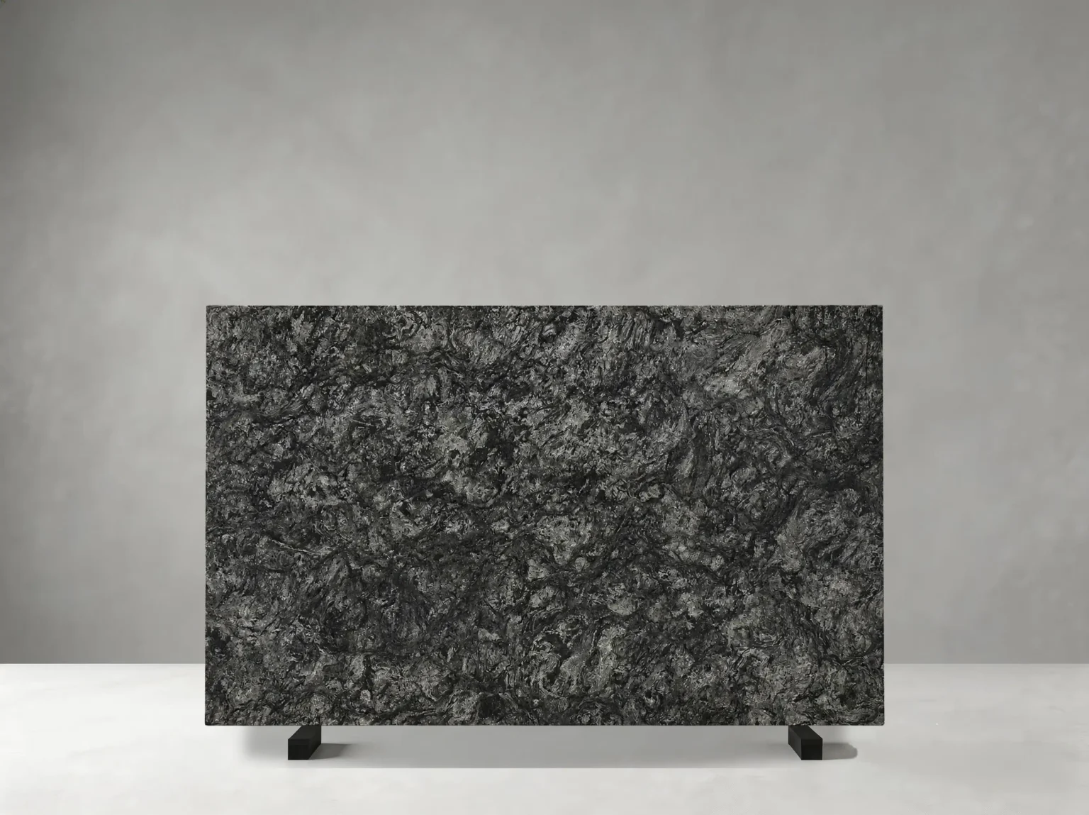kozmus granite slab with charcoal grey and black flowing mineral texture