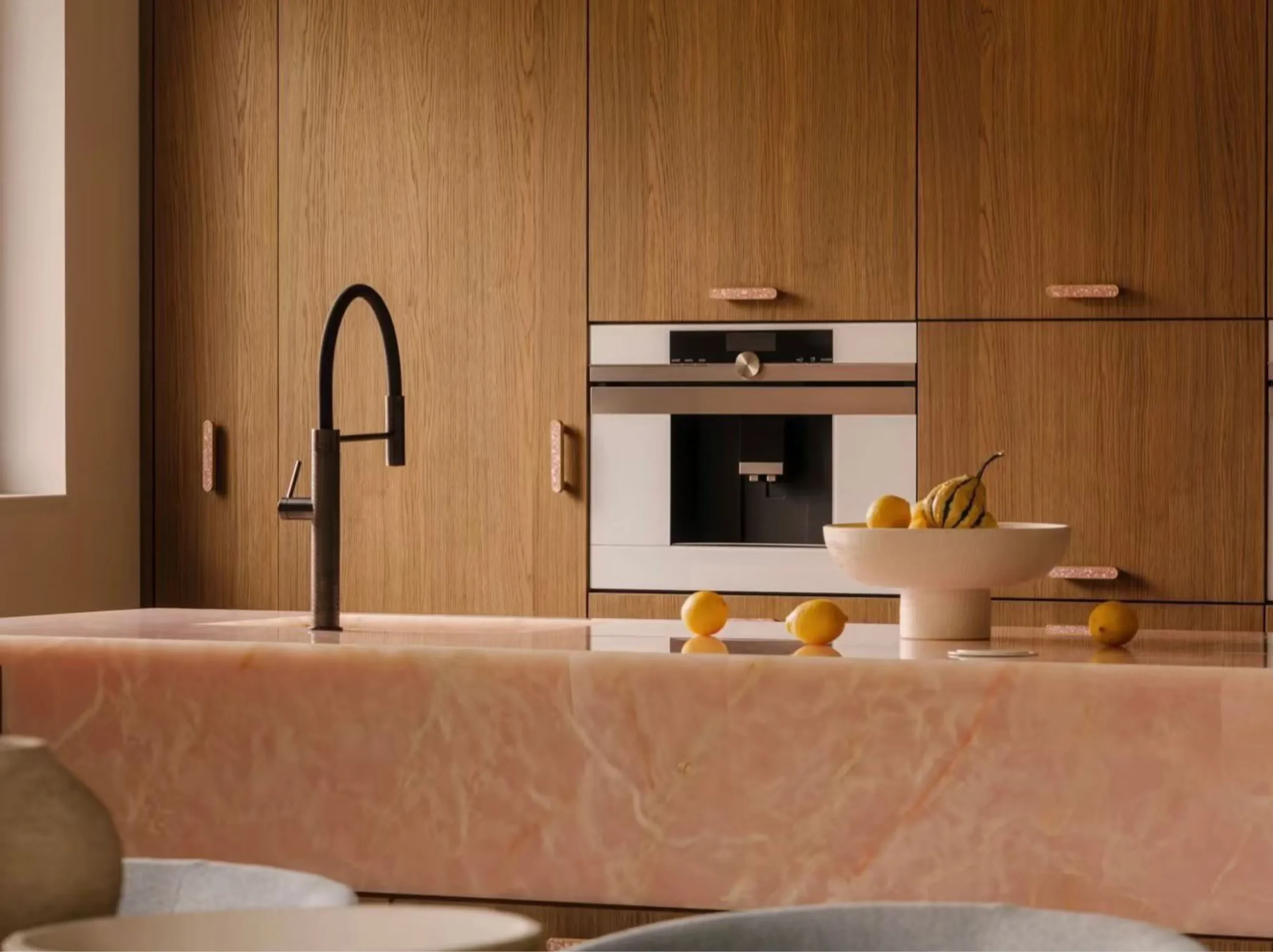 light-pink-onyx-kitchen-island-modern-interior-03.webp Light Pink Onyx kitchen island with integrated sink in a modern wood interior