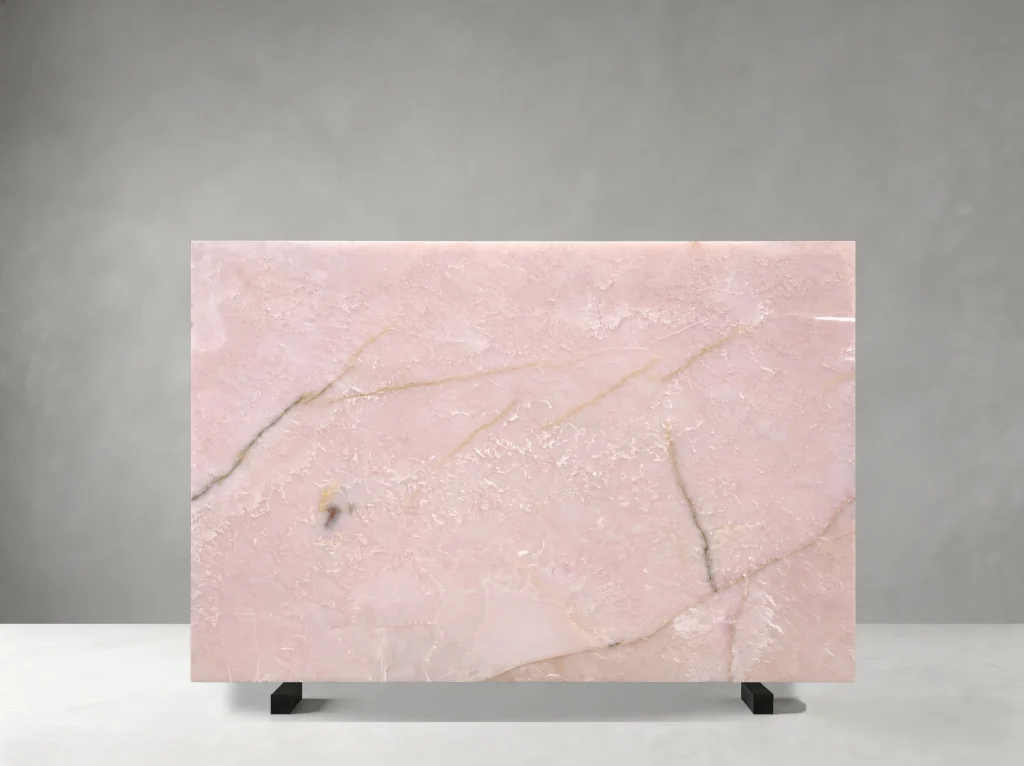 Front view of a polished Light Pink Onyx slab with pale blush colour and fine golden mineral veins