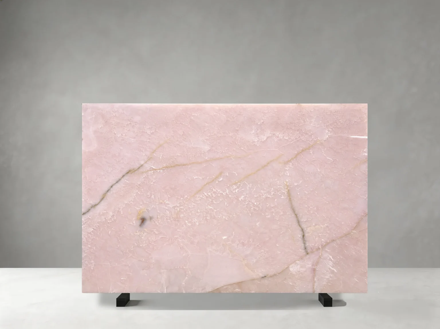 Front view of a polished Light Pink Onyx slab with pale blush colour and fine golden mineral veins