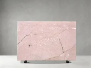 Front view of a polished Light Pink Onyx slab with pale blush colour and fine golden mineral veins