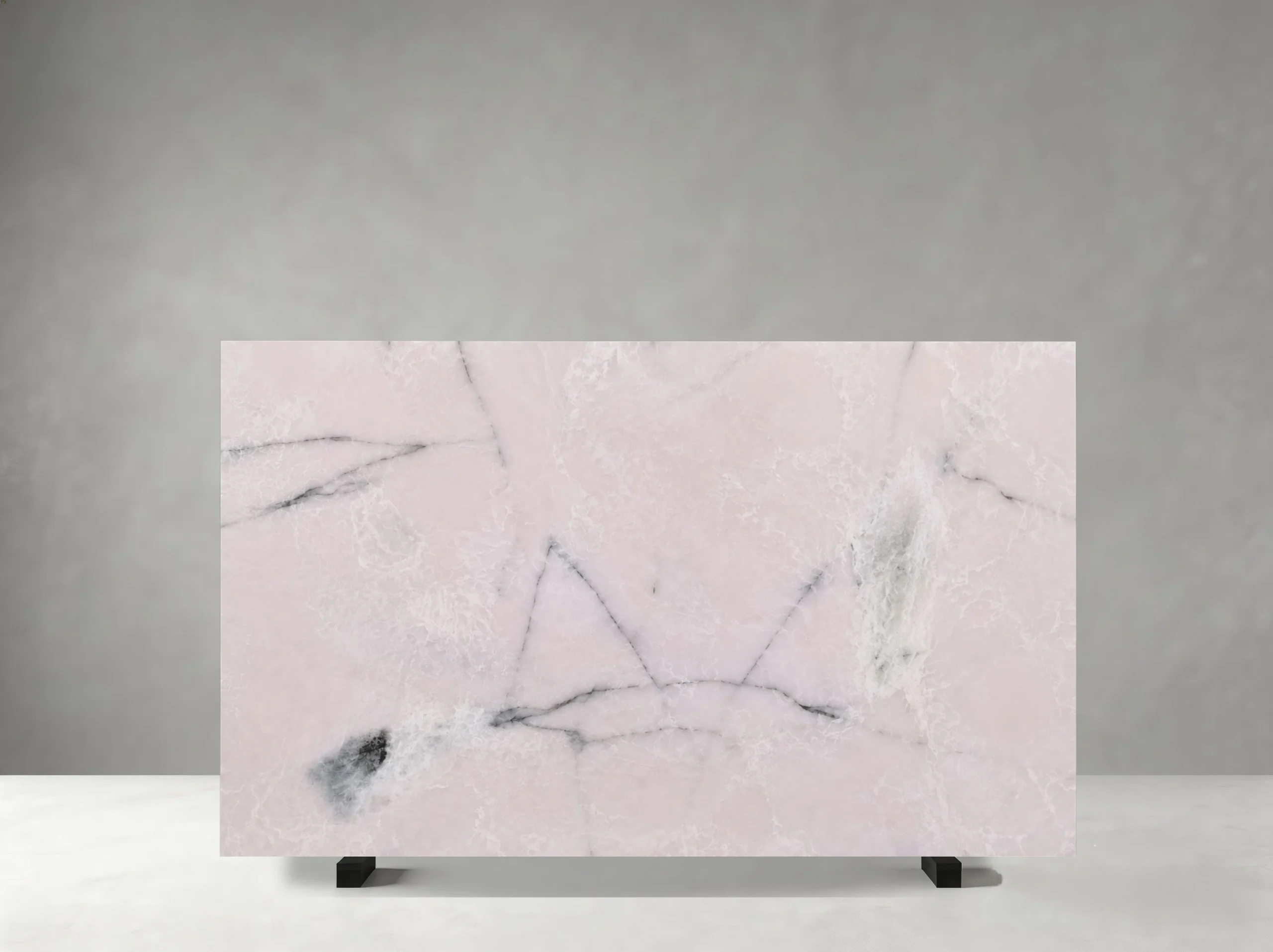 light-pink-onyx-slab-grey-veins-front-view-05.webp Polished Light Pink Onyx slab with pale pink crystalline areas and fine grey mineral veins