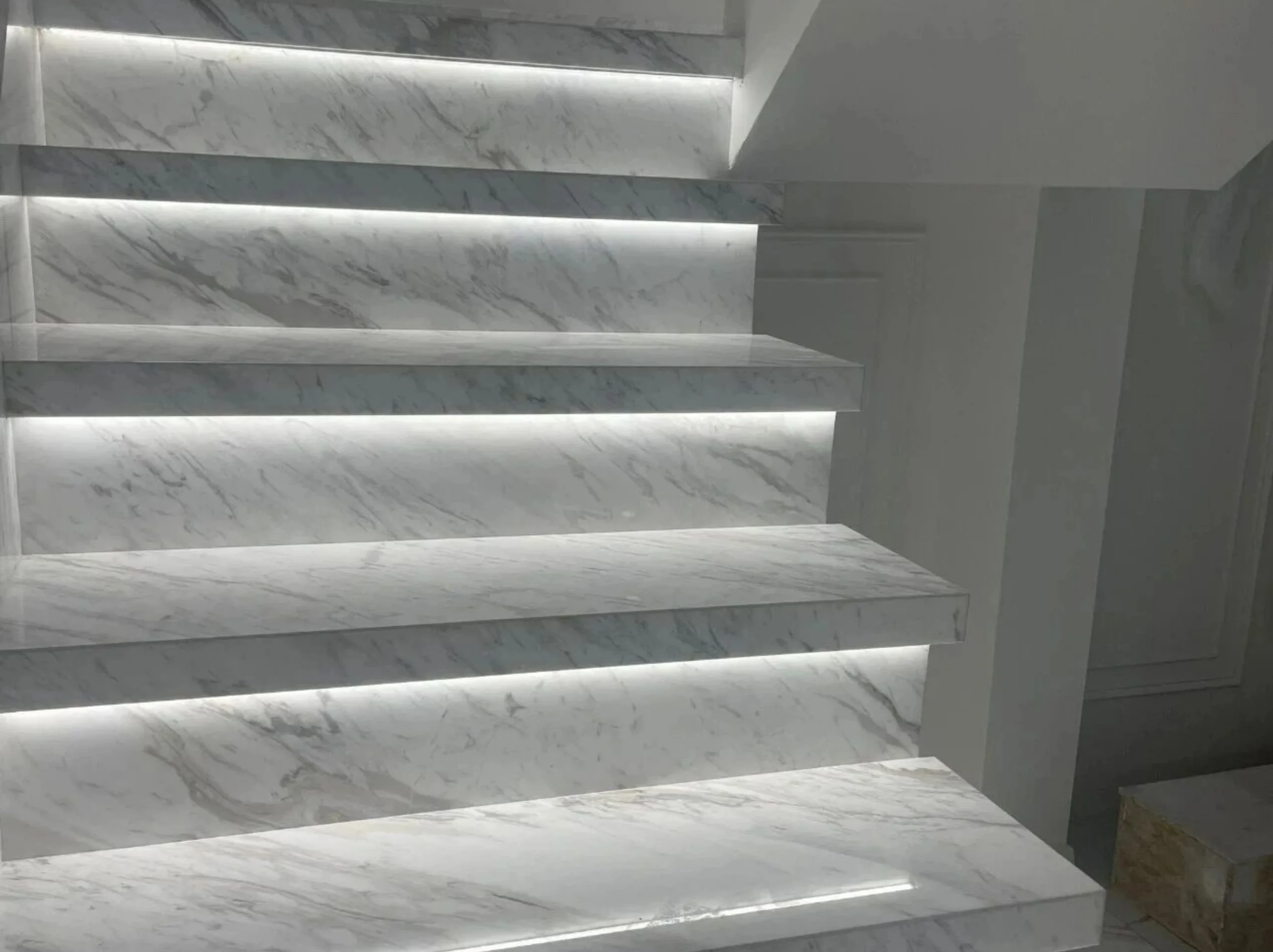 macedonian-white-marble-led-staircase-treads-risers.webp Macedonian White Marble LED staircase treads and risers with grey veining