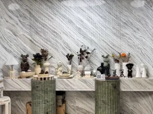 Marmi Bianco Ondulare Marble showroom feature wall with green display counter