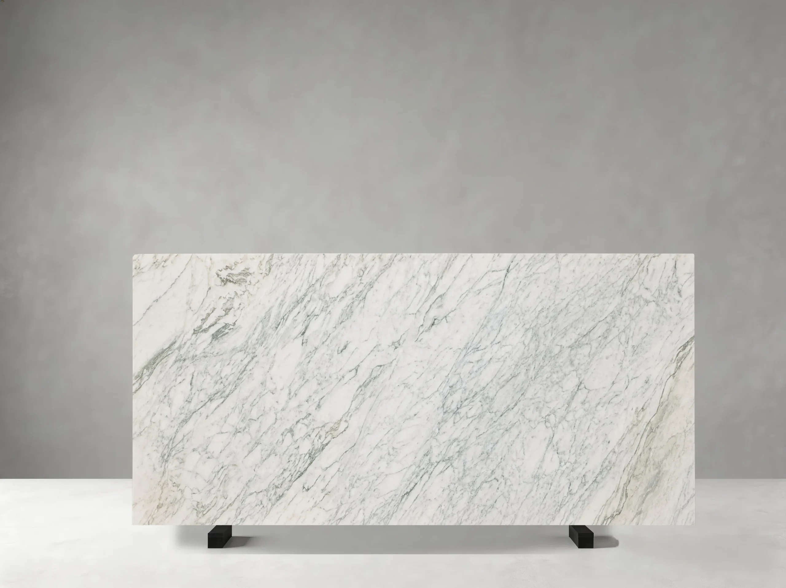 marmi-bianco-ondulare-marble-soft-grey-vein-slab.webp Marmi Bianco Ondulare Marble slab with soft flowing grey veins on a white background