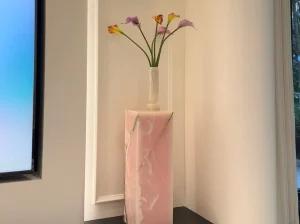 Custom Onice Rosso decorative pedestal with rose-pink onyx patterns in a modern luxury interior