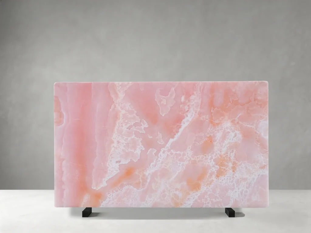 Front view of a polished Onice Rosso slab with rose-pink, peach, and white crystalline patterns