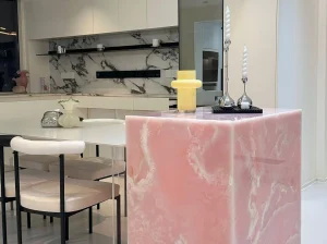 Backlit Persian Pink Onyx kitchen island with translucent pink panels in a modern luxury interior