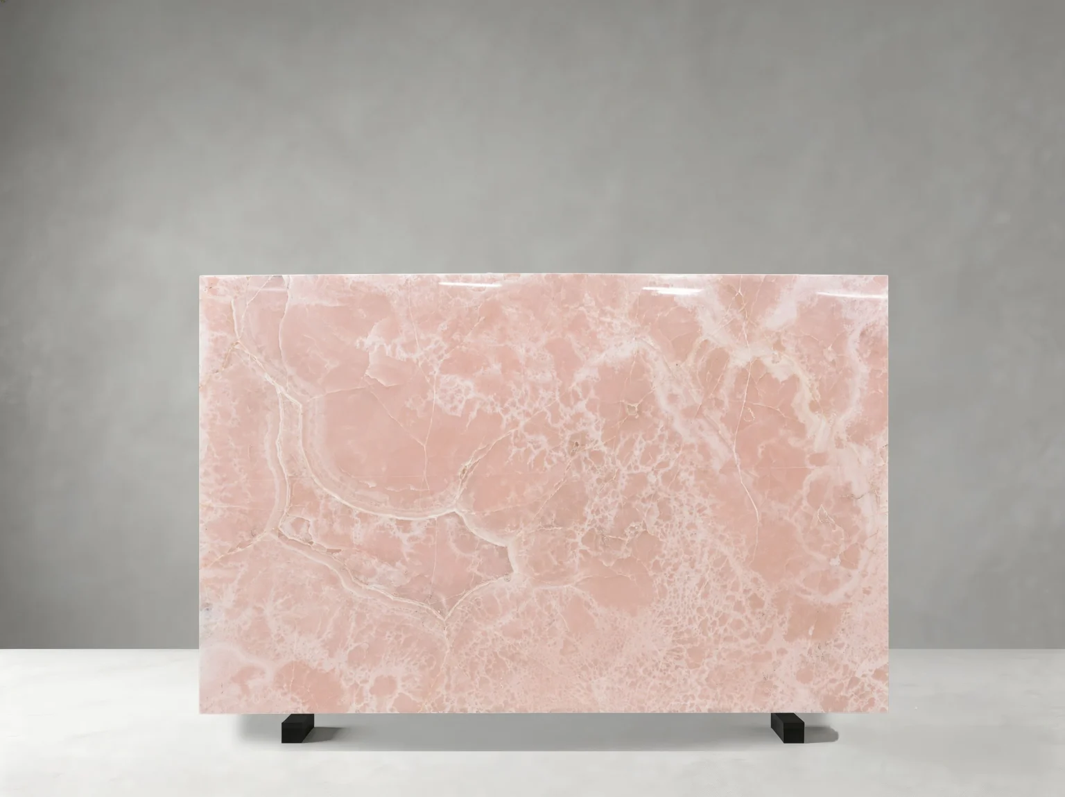 Front view of a polished Persian Pink Onyx slab with blush-pink tones and ivory crystalline patterns