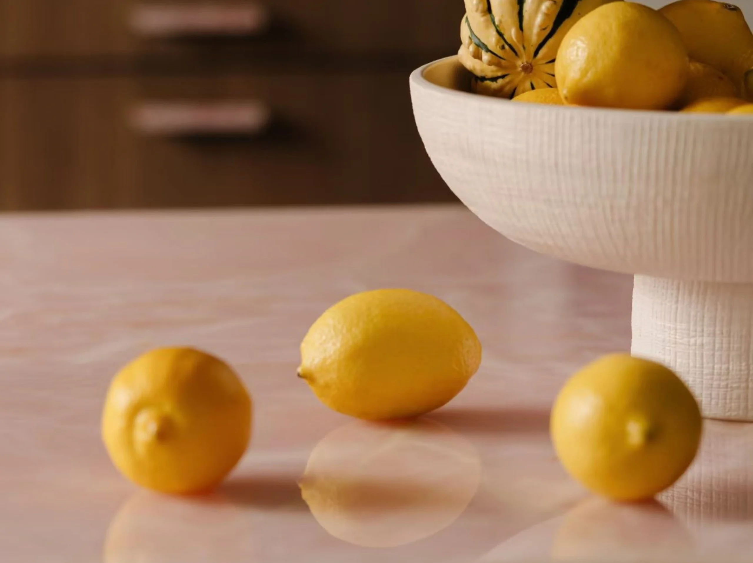 persian-pink-onyx-tabletop-polished-luxury-interior-01.webp Polished Persian Pink Onyx tabletop with soft blush tones displayed with lemons in a luxury interior
