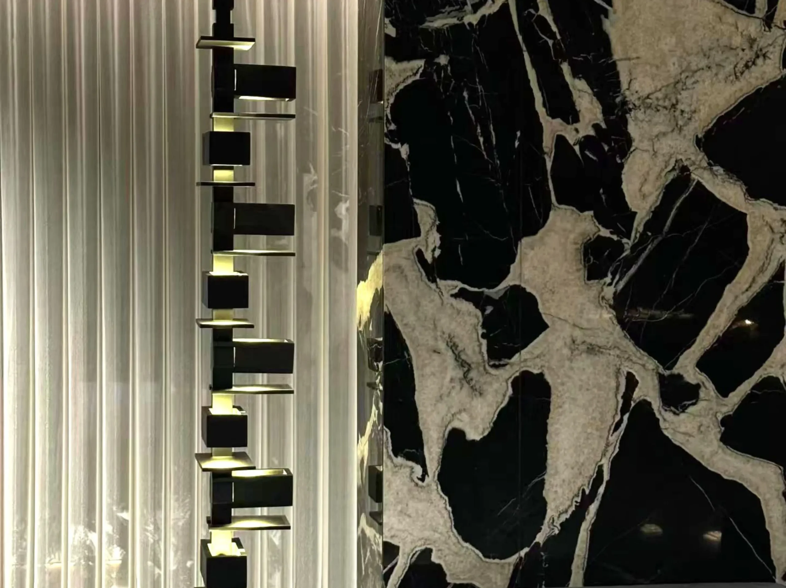 petit-antique-marble-wall-cladding-stair-feature-02.webp petit antique marble wall cladding with black and ivory breccia pattern for luxury interiors