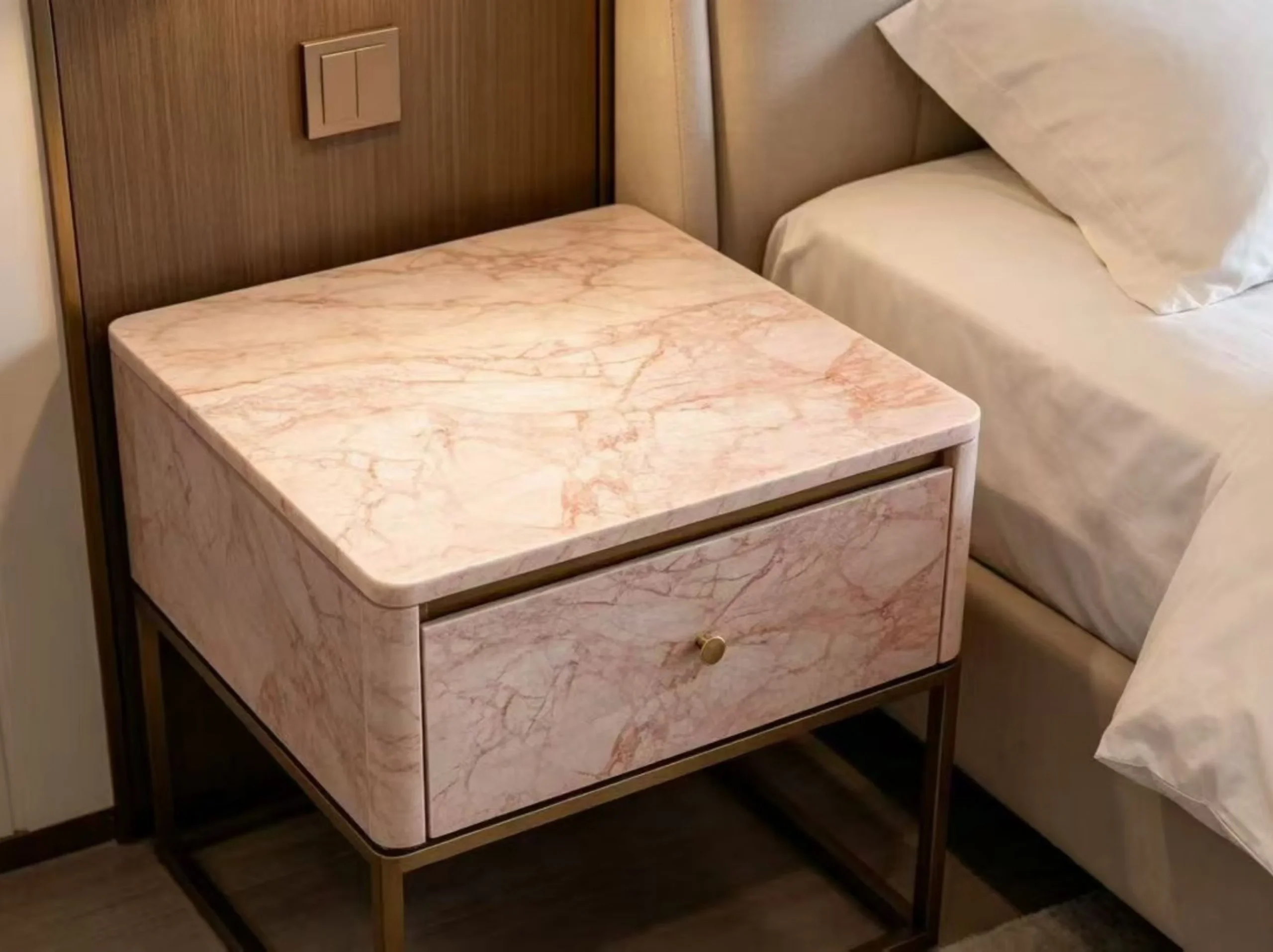 pink-bvlgari-marble-bedside-table.webp Custom bedside table clad in Pink Bvlgari Marble with a metal frame