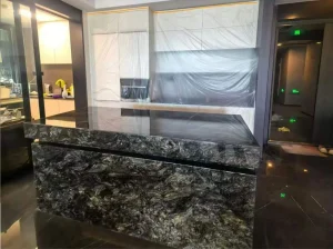 platinum black granite reception counter with dark charcoal and silver mineral movement