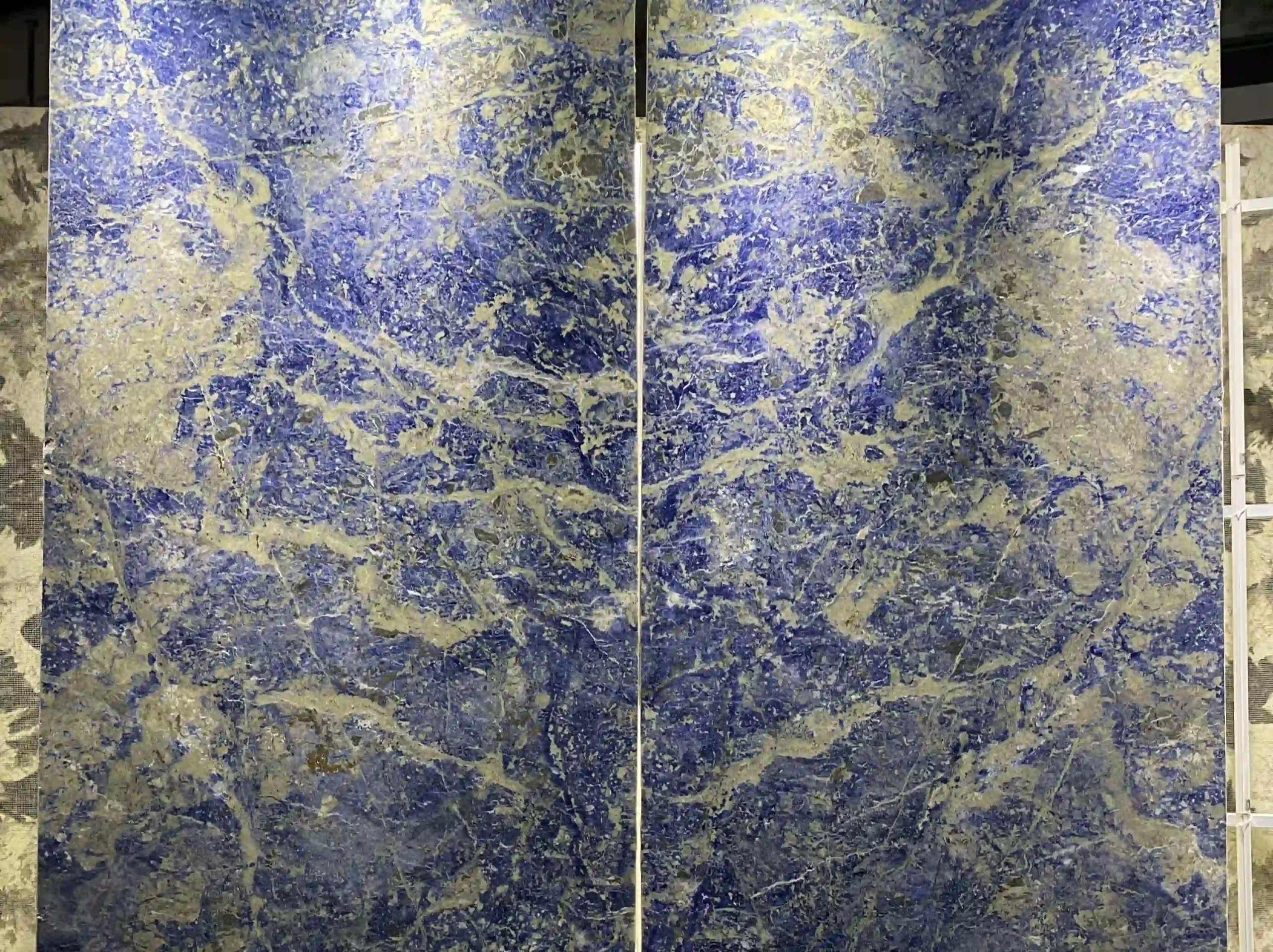 royal-blue-sodalite-marble-matched-slab-display-03.webp royal blue sodalite marble matched slabs with vivid blue cream and grey mineral movement