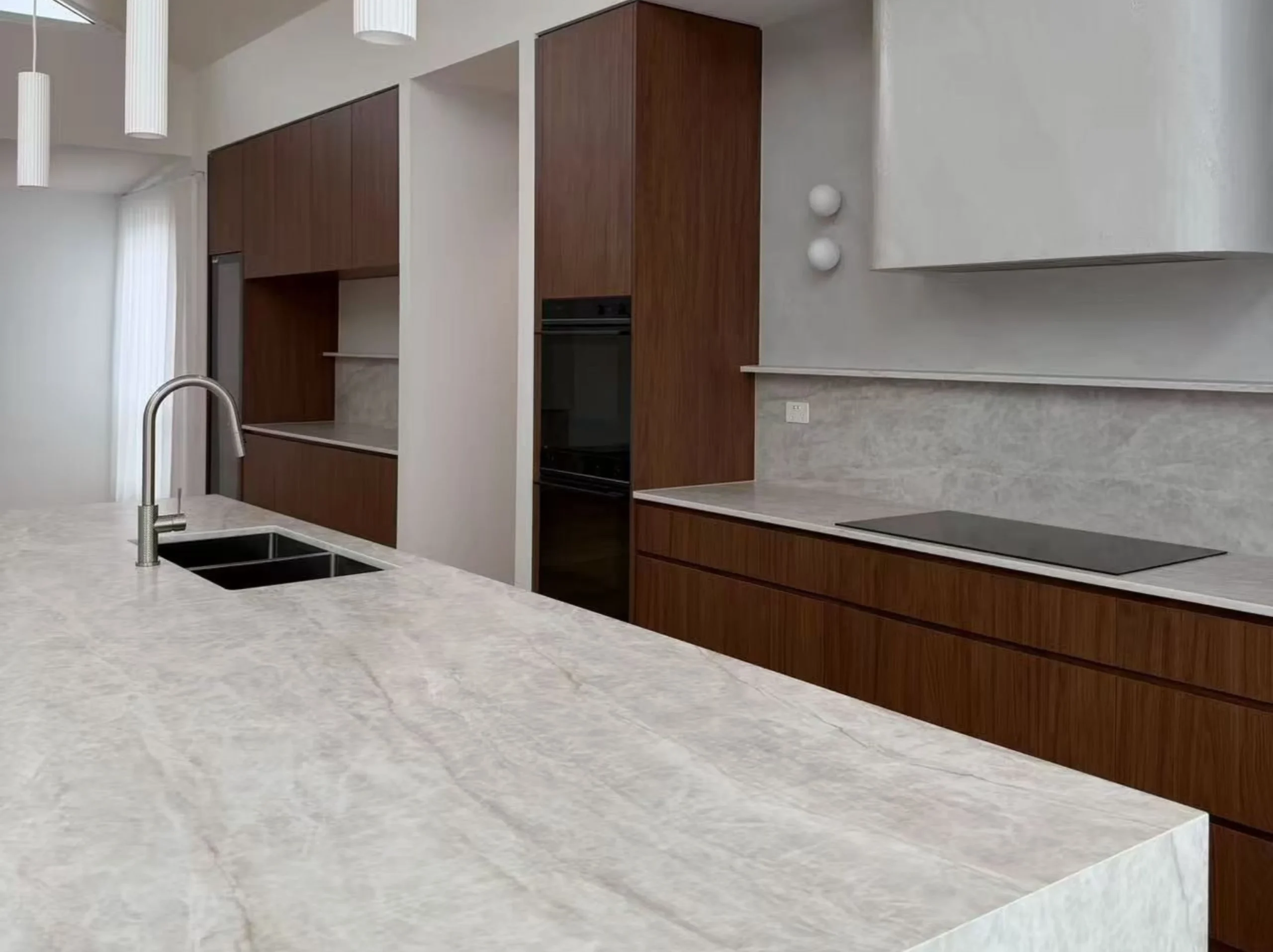 taj-mahal-white-quartzite-kitchen-island.webp Taj Mahal White Quartzite kitchen island with light neutral tones and natural veining