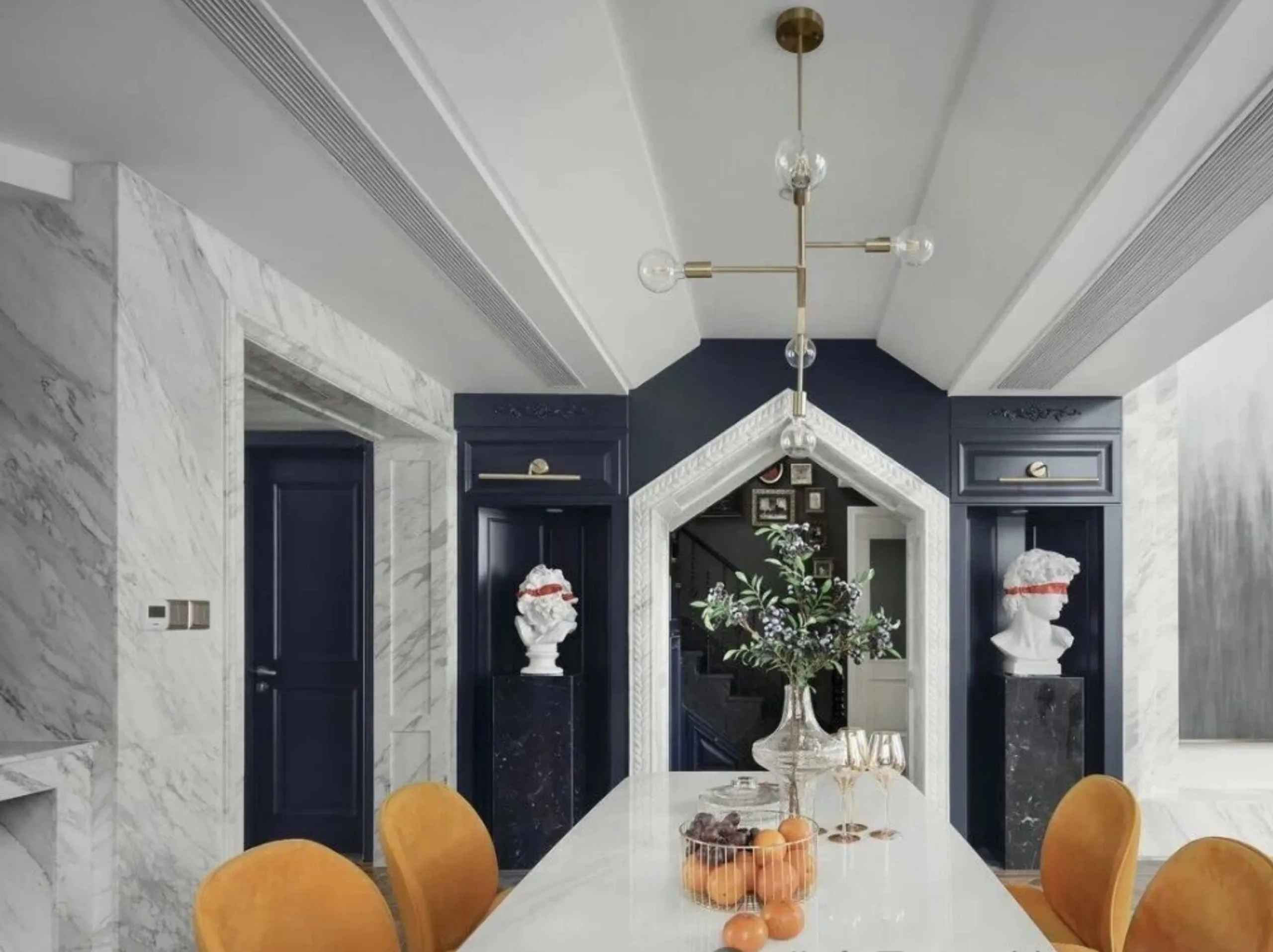 volakas-drama-white-marble-luxury-dining-room-hero.webp Luxury dining room with Volakas Drama White Marble wall cladding, doorway and custom dining table