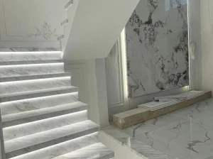 Volakas Marble staircase with custom treads, risers and integrated LED lighting
