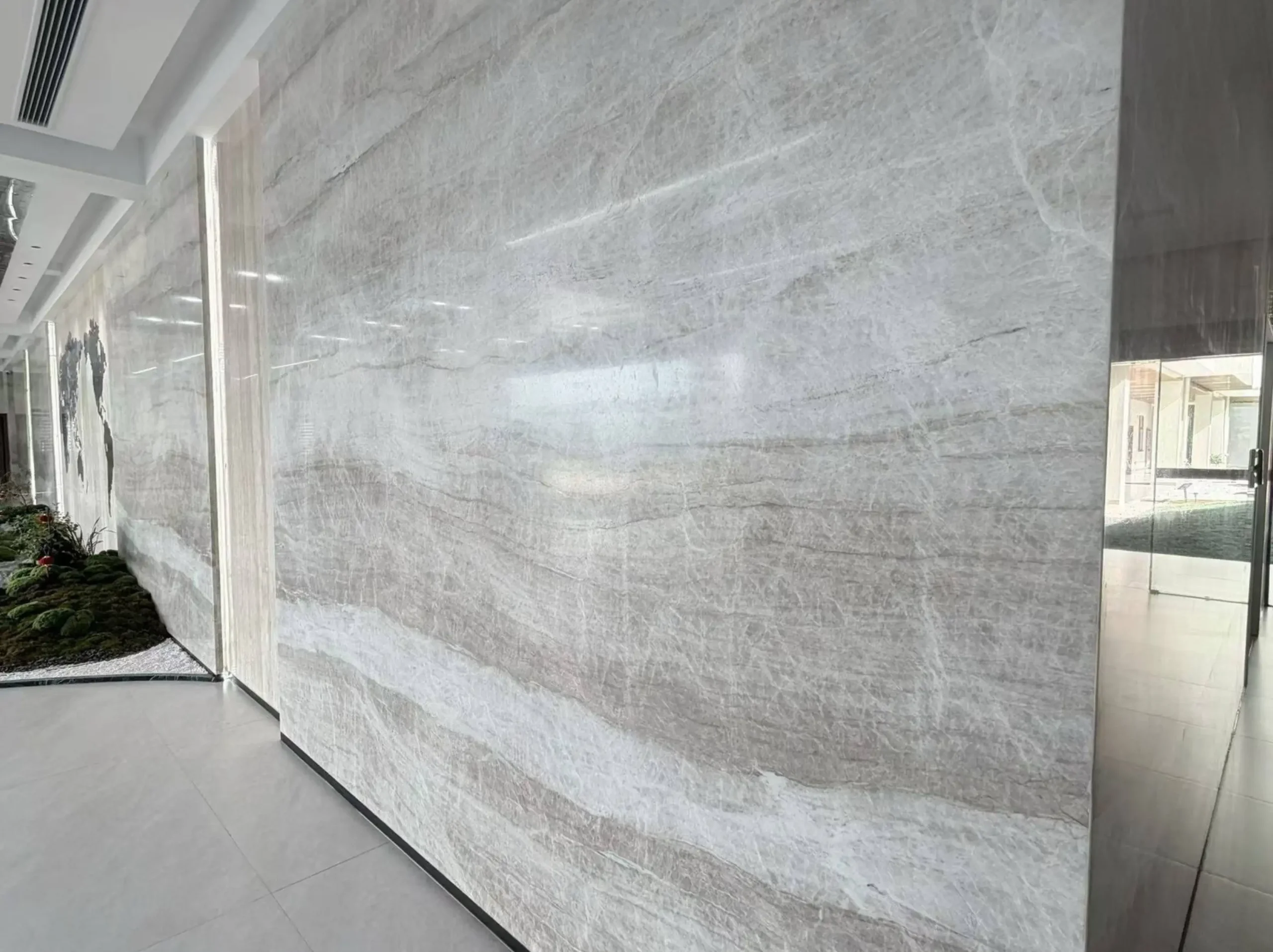 white-perla-venata-quartzite-architectural-wall-cladding.webp White Perla Venata Quartzite architectural wall cladding with curved custom stone panels