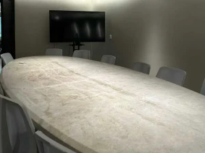 Custom White Taj Mahal Quartzite meeting table with a large rectangular stone top