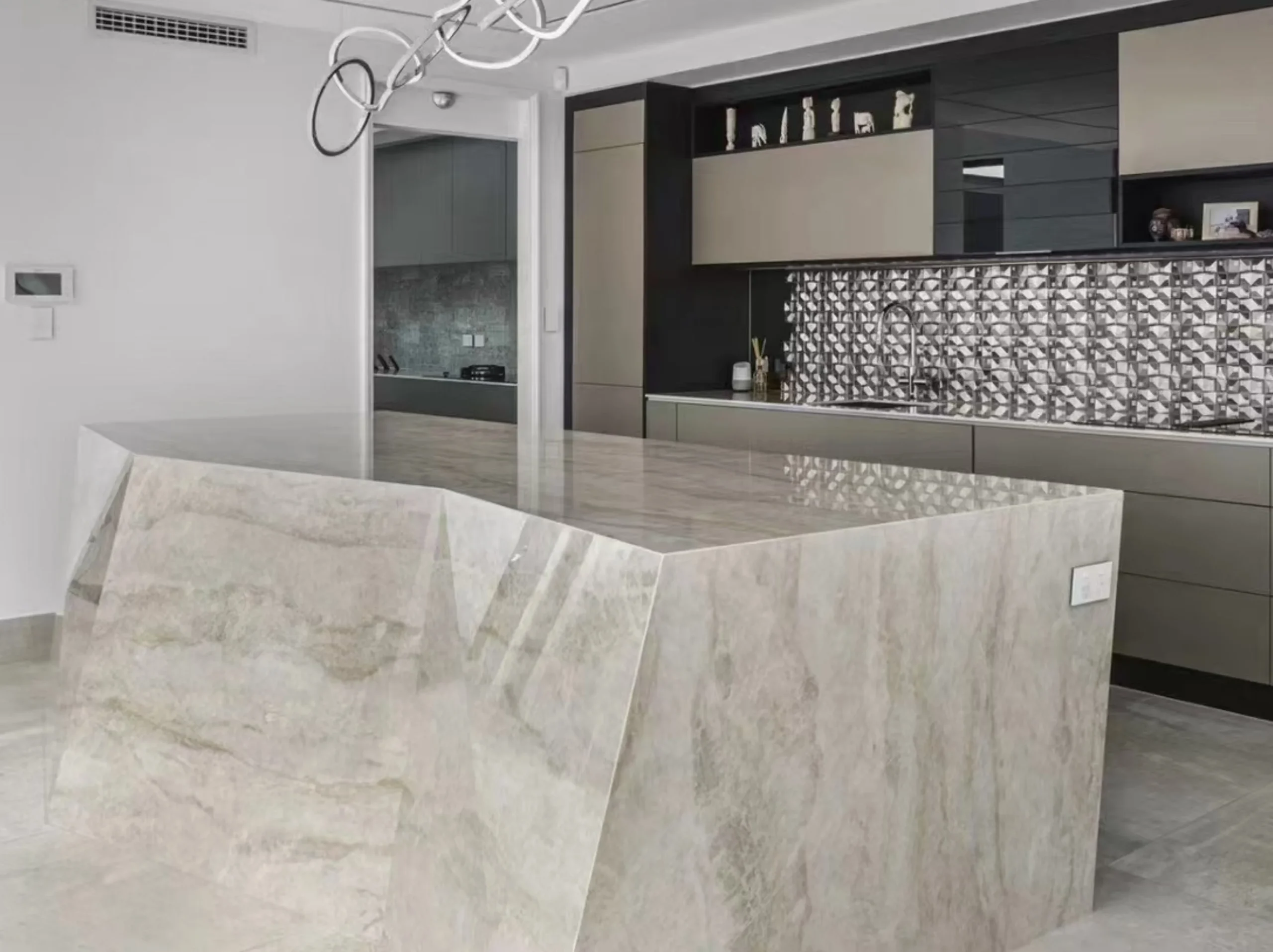 white-taj-mahal-quartzite-waterfall-kitchen-island.webp White Taj Mahal Quartzite waterfall kitchen island in a contemporary luxury interior