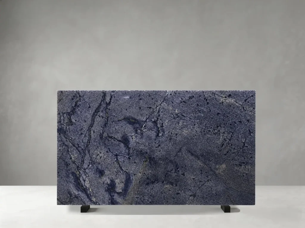 Bahia Azul Granite full slab showing deep navy, indigo, charcoal and muted gold tones with swirling blue-black mineral movement with fine crystalline highlights