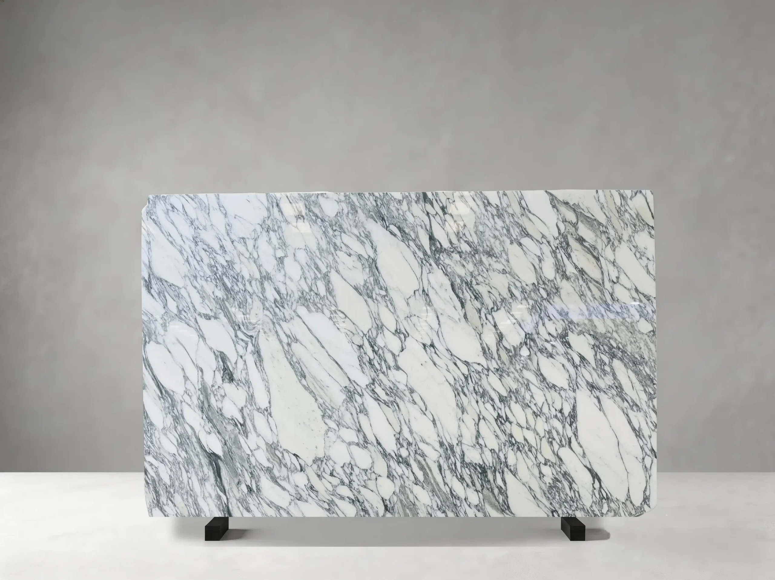 Bianco Arabescato Marble full slab showing white, pale grey and cool blue-grey tones with layered grey veining, fragmented mineral fields and occasional warm accents
